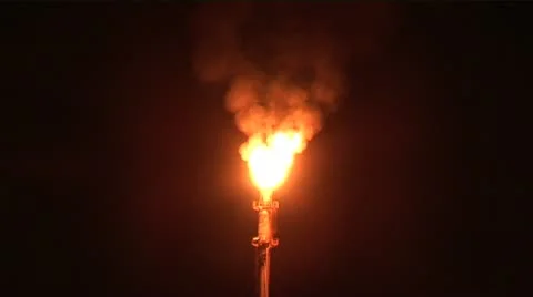 Flames roar from chimney of Exxon gas processing plant in Indonesia Stock Footage 11799370