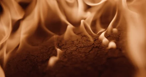 Flames roll off a charred cracked board Stock Footage 102789857