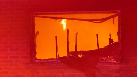Flames through broken window Stock Footage 104299024