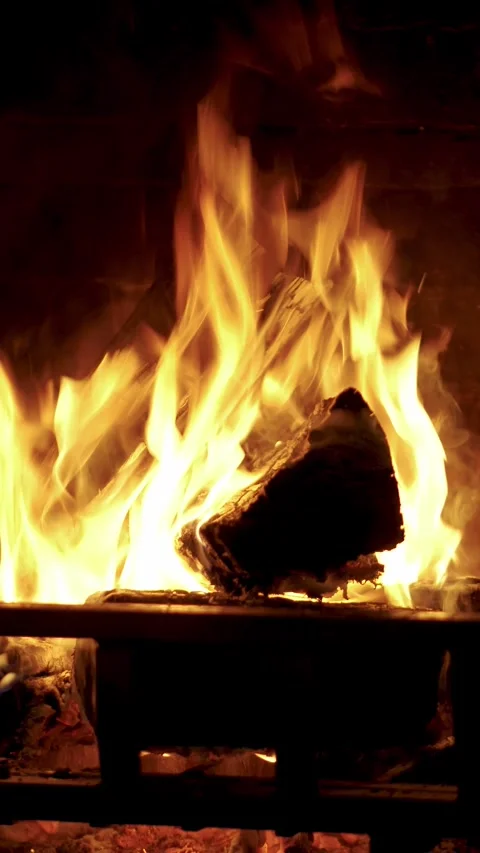 Flames of warm fire burning in the Fireplace. Close up video shot Stock Footage 285543911