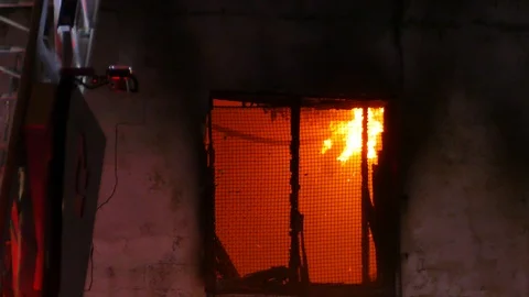 Flames in the window of vacant building Stock Footage 115974418