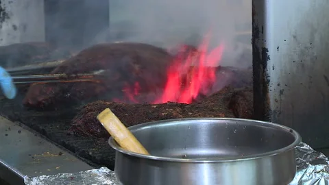 Flaming bbq tri-tip meat grilled in restaurant for takeout covid pandemic Stock Footage 145445130