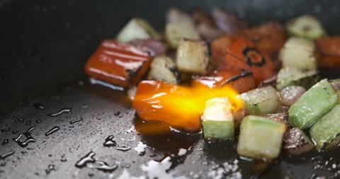 Flaming, burning vegetables cooking in pan, frying veggies. Zucchini and pepper. Video stock 133416726