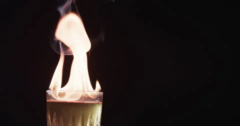 A flaming cocktail ignites with dramatic effect, with copy space Stock Footage 266474791