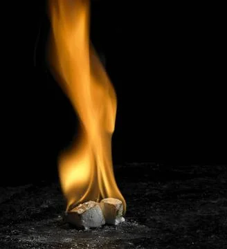 Flaming cubes big flame on small burning cubes in dark back Copyright: xZo... Foto stock
