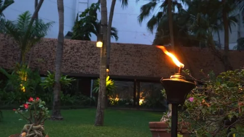 Flaming fire on retro oil lantern with garden background, Stock Footage 88142464