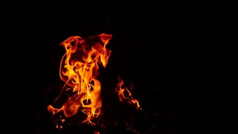 Flaming flames on a black background Stock Photos