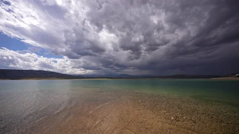 Flaming Gorge with stormy clouds moving overhead from colorful beach area Stock Footage 211837765