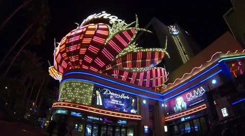 Flamingo hotel Las Vegas front neon flame display lights up the night sidewalk Stock Footage
