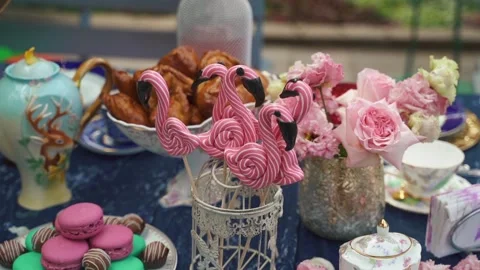 Flamingo-shaped sweets on the festive table, among the sweets and decoration Stock Footage 196218110