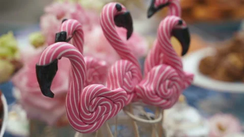 Flamingo-shaped sweets on the festive table, among the sweets on the holiday Stock Footage 196218310