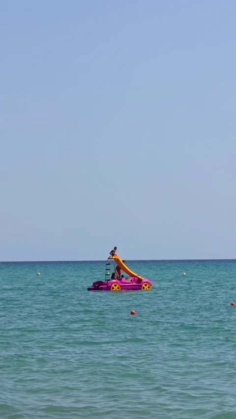 Flamingo Slide Boat Floating on Open Turquoise Sea Video stock 344371453