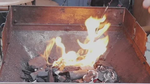 Flammable Liquid For Ignition Is Poured On An Open Fire In The Grill. Stock Footage 237532369