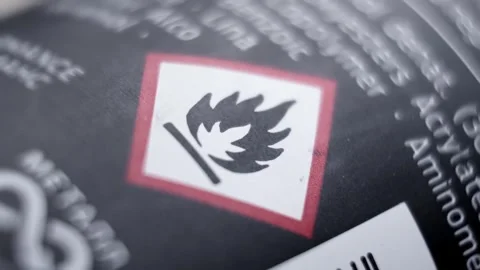 Flammable sign on black packaging. Warning. Concept of safety. Black bottle. Stock Footage 264945299
