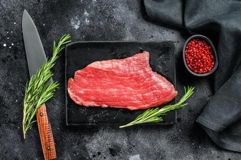 Flank steak. Raw Marble beef meat black Angus. Black background. Top view Stock-Fotos