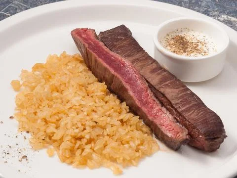 Flank steak with risotto and pepper sauce Stock Photos