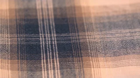 Flannel fabric with a checkered pattern of beige brown color. rotating. closeup. Stock Footage 243190360