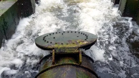 Flap valve swings while water flows through a pipe Stock Footage 270380417