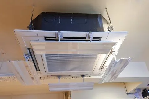 Flaps attached to air conditioner unit to disperse cold air evenly in room Stock Photos