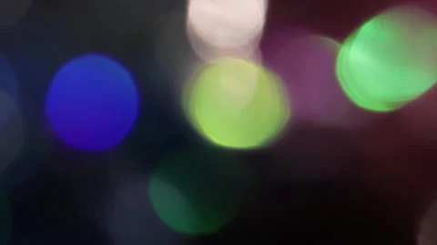 Flare of colored bokeh lights shines in the dark. 스톡 동영상 317459564