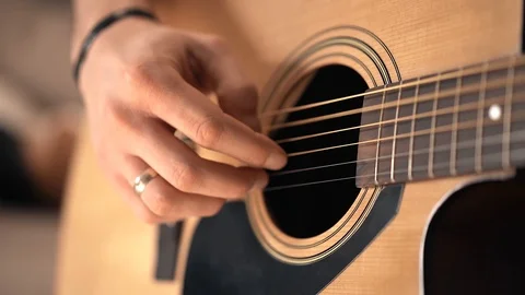 Flare effect. Slow motion. Acoustic guitar and sunlight. The guy is playing the  Stock Footage 127485205