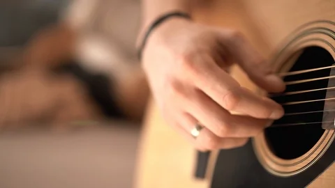Flare effect. Slow motion. Acoustic guitar and sunlight. The guy is playing the  Stock Footage 127485332