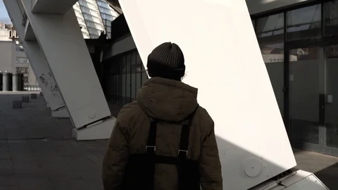 Flare effect. Slow motion. Urban city. A leaving guy in a jacket. Stock Footage 127485262