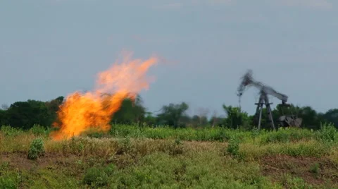 Flare Stack Burning In Oil Well While Producing Natural Gas Video stock 55369984