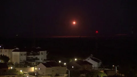 Flares light up night sky, smoke rises f… | Stock Video | Pond5