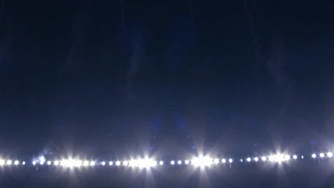 Flaring stadium lights and pyro fireworks in the stadium at night Stock Footage 102100664