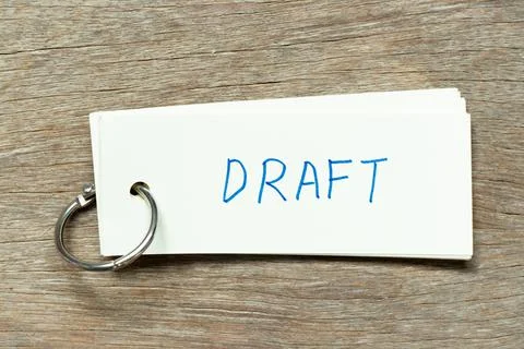 Flash card with handwriting word draft on wood background Stock Photos