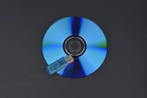 Flash card lying on a disk on a dark grey background Stock Photos