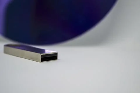 A flash drive and a COMPACT disc on a white background. Foto stock