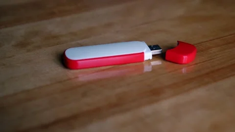 Flash drive with cap lies on brown wooden polished table Video stock 114797595