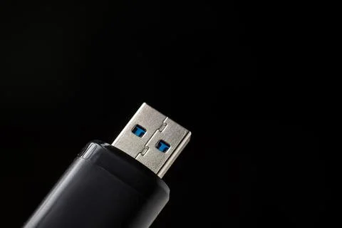 Flash drive close-up on a black background. Data safety concept. Stock Photos