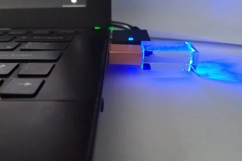 Flash drive inserted into laptop. Data transmission technologies. Stock Photos