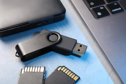Flash drive, SD memory cards, external hard disk and laptop on light grey t.. Stock Photos