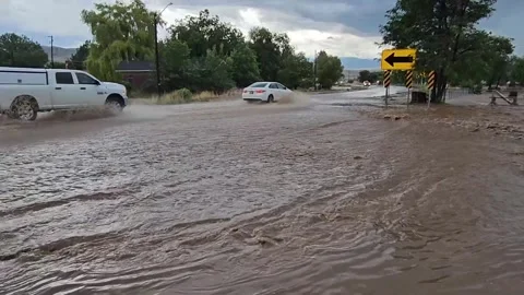 Flash Flood running down street-Cars splashing Video stock 283236506