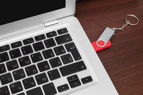 Flash memory drive plugged into a laptop port Stock Photos