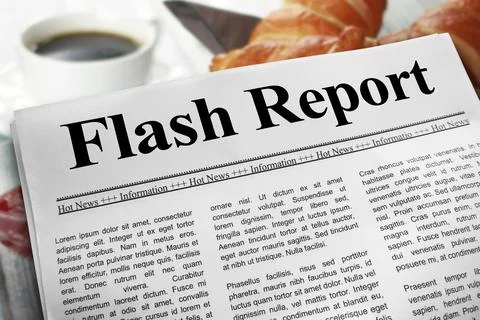 Flash Report in newspaper layout on a breakfast table with a blurry cup of .. Stock Photos