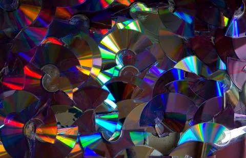 Flashed with different colors of broken DVD discs. Stock Photos