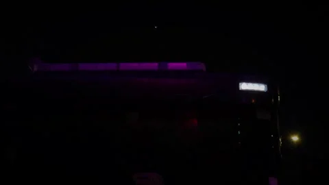 Flashes of amber and red lights illuminate the dark, signaling an emergency Video stock 311765387