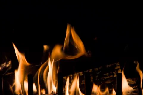 Flashes of bright flames on a dark background 写真素材