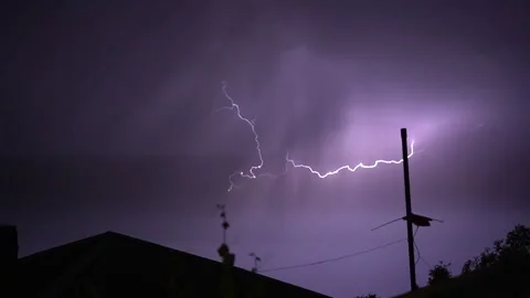 Flashes of lightning over the night street illuminate the house Stock Footage 276328835