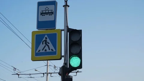 Flashing and changing traffic light color against the blue sky Stock Footage 127151976