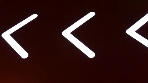 Flashing arrow, sign, pointer on a dark background. Luminous road signs Stock Footage 119915976