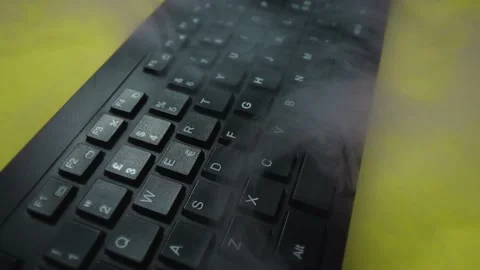 Flashing of colors on wireless computer keyboard and steam clouds on red closeup Видео 141135105