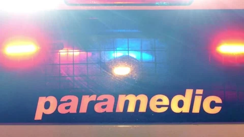 Flashing emergency lights in the back window of paramedic vehicle at the 스톡 동영상 150344365