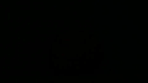 Flashing glowing jack-o-lantern lit from inside on black background Stock Footage 313081252