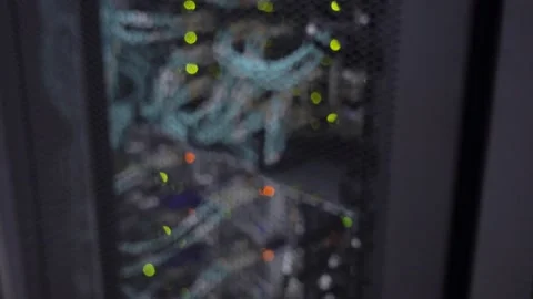 Flashing green lights, blurred server rack. The video contains noise. 動画素材 140921096